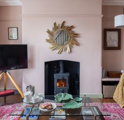 A living room with a fireplace and television at Astondene, East Cliff, Southwold