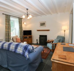A living room with a sofa and television at Chandos in Dolwyddelan
