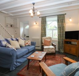 A living room with a sofa and armchair at Chandos in Dolwyddelan