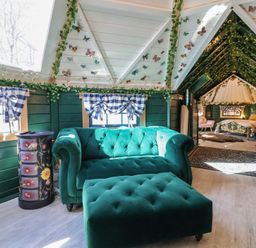 A living room with a sofa and ottoman at Applejacks Orchard in Holywell