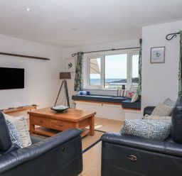 A living room with a coffee table and a television at 4 Burgh Island Causeway in Bigbury