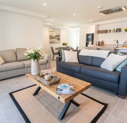 A living room with two sofas and a wooden coffee table at 31 Cliff Edge in Newquay