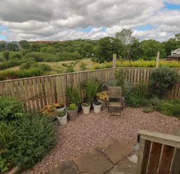 A garden with potted plants and a view of the landscape at Garden View in Pembroke