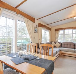 A living room with a table and sofa at Little Malory St Giles-On-The-Heath