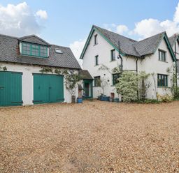 A house with a garage and gravel driveway at White House