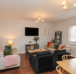 A living room with sofas and a coffee table at The Pheasantry in Flamborough