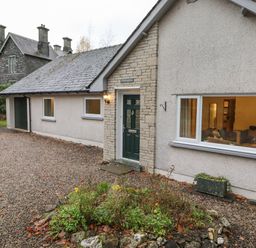 The exterior of a single story house with a garden bed and gravel driveway at Tandarra in Keswick