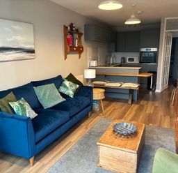 A living room with a sofa and coffee table at 9 Oakley Wharf in Porthmadog