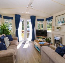A snug with a sofa and television at 25 Foxburrow Hang in Fritton near Belton