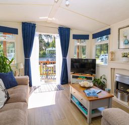 A snug with a television and a coffee table at 25 Foxburrow Hang in Fritton near Belton