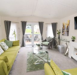 A living room with green sofas and decorative items at The Haven