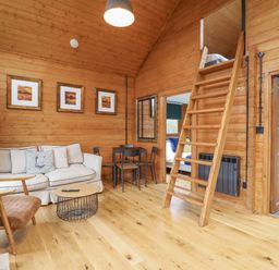 A living room with sofa and dining table at Squirrel's Nest in South Luffenham near Edith Weston