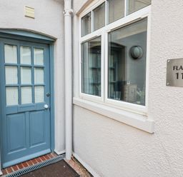 An entrance with a blue door and window at 11 The Craighurst Southwold