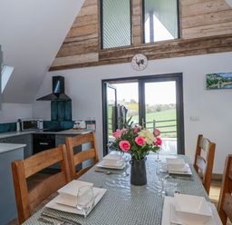 A kitchen with a dining table and chairs at Valley View Hideaway in Ffostrasol