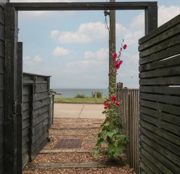 A pathway leading to the sea at The Artist's Cabin By The Sea Herne Bay