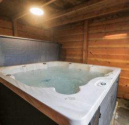 A hot tub in a wooden room at The Bevan in Bontnewydd, Gwynedd
