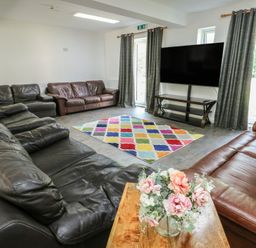 A living room with sofas and a television at The Bevan in Bontnewydd, Gwynedd