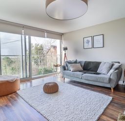 A living room with a sofa and window at Hafod Y Bryn in Harlech