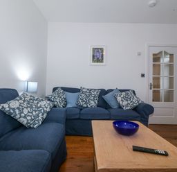 A living room with a sofa and coffee table at Ty Capel Bethania in Nant Gwynant