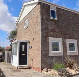 A house exterior with a door and windows at Lavender Cottage in Beadnell