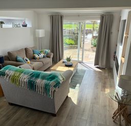A living room with a sofa and coffee table at Lavender Cottage in Beadnell
