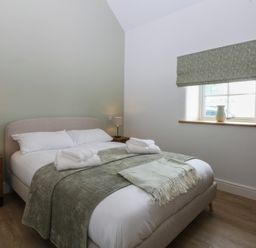 A bedroom with a bed and nightstand at Beudy