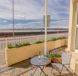 An outdoor area with a table and chairs at Sea Lovers in Exmouth