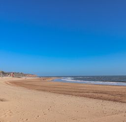 A beach scene with sand and water at Sea Lovers in Exmouth