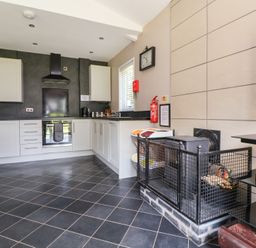 A kitchen with cabinets and an oven at The Fallows in Llanerch Park near St Asaph