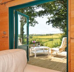 A seating area with a view of outdoor landscape at Owl Lodge Menheniot