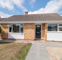 A house with a black front door and windows at No 8 Burnham-on-Sea