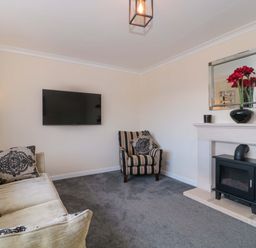 A living room with a sofa and TV at No 8 Burnham-on-Sea