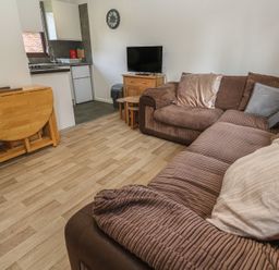 A living room with a sofa and TV at Tolroy Manor Holiday Park St Erth Praze near Hayle