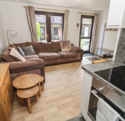 A living room with a sofa and coffee table at Tolroy Manor Holiday Park St Erth Praze near Hayle