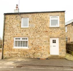 A stone house with three white framed windows and a white door at Bridge End Cottage in Wark