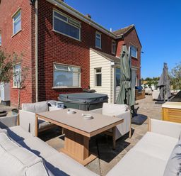 An outdoor area with furniture and a barbecue grill at The Farmhouse in St. Osyth