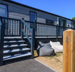 An outdoor area with stairs and bean bags at Lakewood Plot 2 St. Osyth