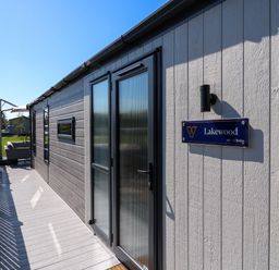 An exterior view of a building with a sign for Lakewood in St. Osyth