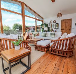 A living room with a sofa and chairs at Burlodge Swimbridge near Barnstaple