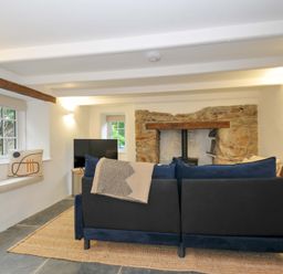 A living room with a sofa and television at Sunrise Cottage St Kew Highway near Wadebridge