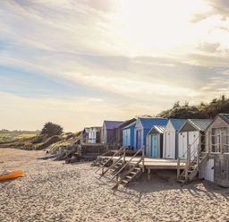 Beach huts on sand at Northwood Lodge Llanbedrog