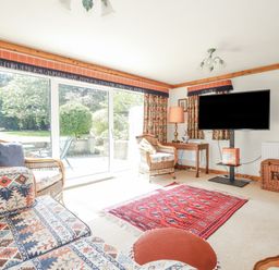 A snug with seating area and television at Temple House in Goonhavern