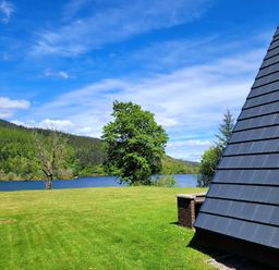 A view of a lake with trees and mountains at Lodge 2 - Inglewood Lodge Spean Bridge