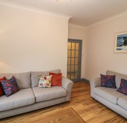 A living room with two sofas and a table at No 1 Lodge Wood Kenmare, County Kerry