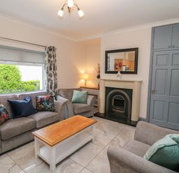 A living room with sofas and a fireplace at No 1 Lodge Wood in Kenmare, County Kerry