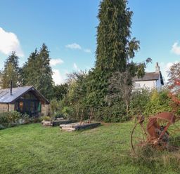 An outdoor area with a cottage, garden, and trees at The Cart Shed in Barwick near Yeovil, Somerset