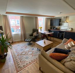 A combined living room and kitchen with a sofa and coffee table at Picadore Two in Scarborough