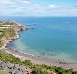 A coastal view with beach and cliffs at Lodge 62 at Riviera Bay Coastal Retreat Brixham