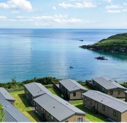 An outdoor view of cabins near the sea at Lodge 70 at Riviera Bay Coastal Retreat Brixham
