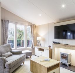 A living room with a television and sofa at Lodge 64 at Riviera Bay Coastal Retreat Brixham